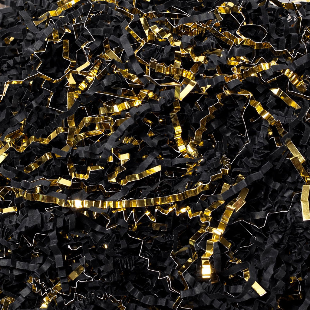 Pile of black and gold crinkle cut paper shred filler for gift boxes and baskets
