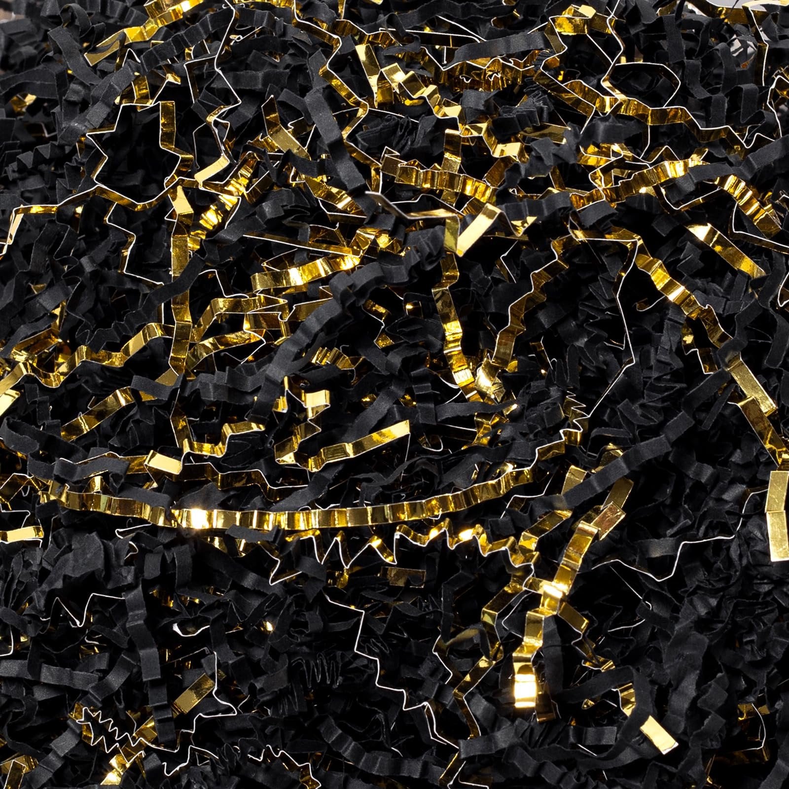 Pile of black and gold crinkle cut paper shred filler for gift boxes and baskets
