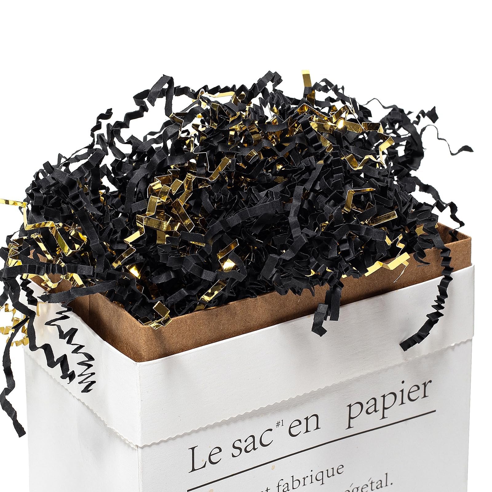 Black and gold crinkle cut paper shred filler overflowing from a white paper gift bag.