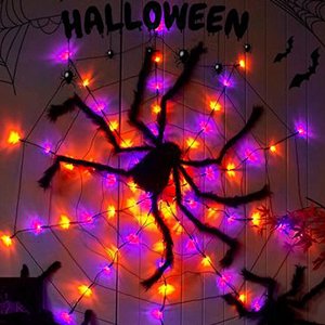 Halloween spider web decoration with orange and purple LED string lights and fuzzy spiders