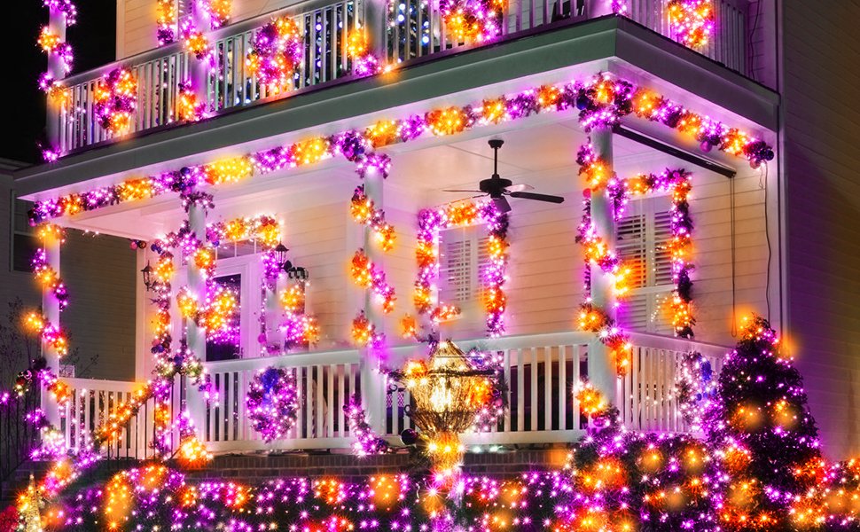 House exterior decorated with orange and purple Halloween string lights on porch and bushes