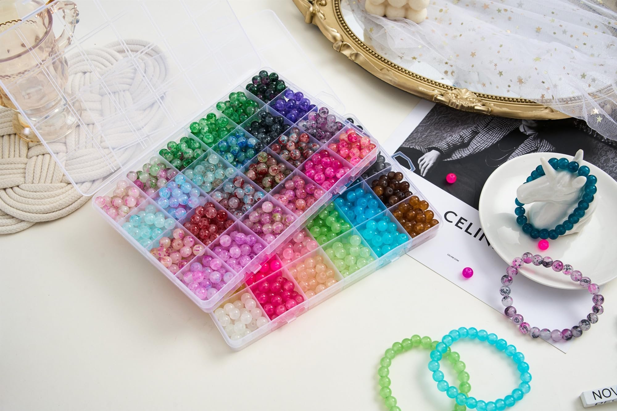 Assortment of 8mm round glass beads in 48 colors, organized in a clear plastic case, with finished bracelets and decorative elements.