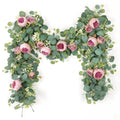 Artificial peony and rose garland with eucalyptus leaves and small white flowers, arranged in an arch shape on a white background.