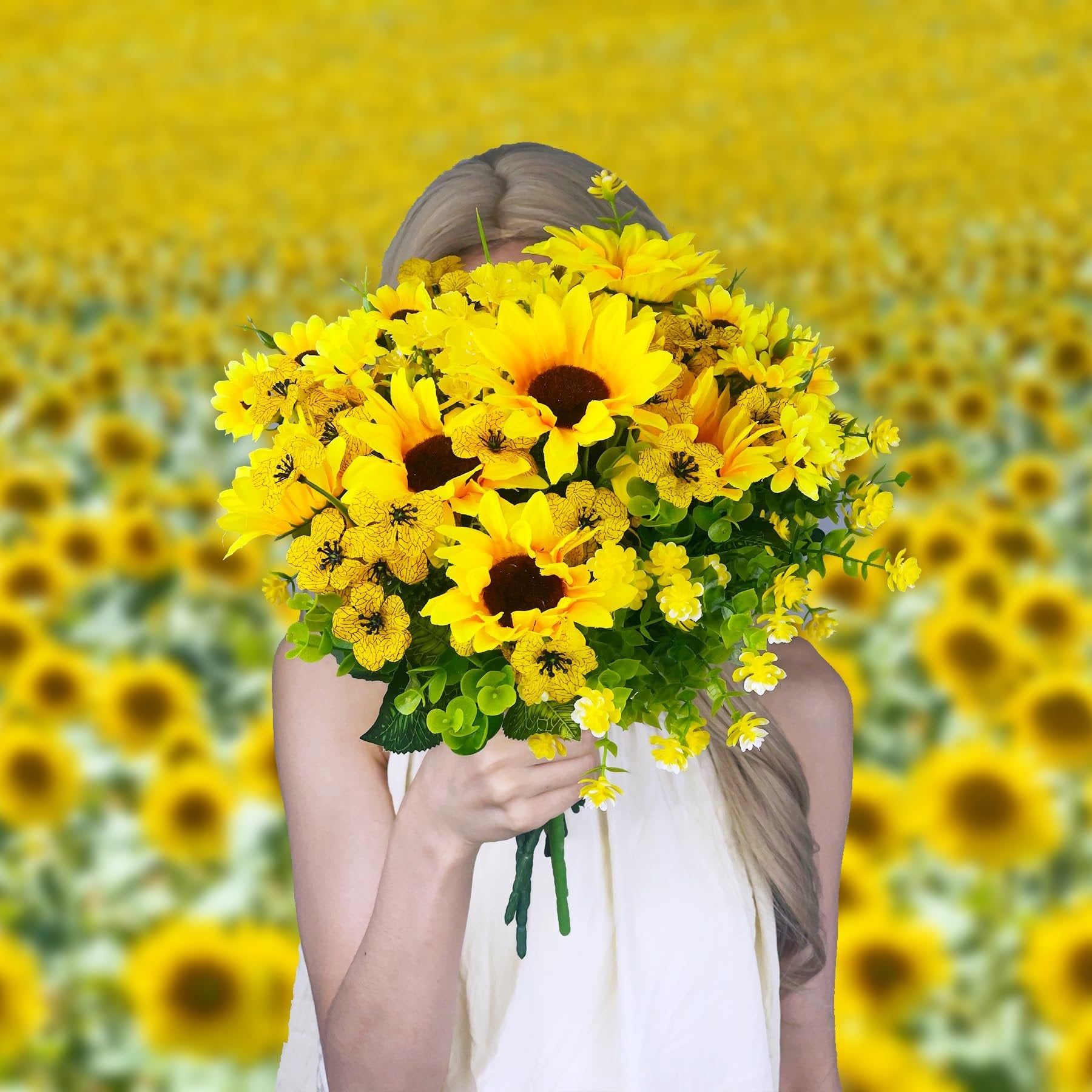 Woman holding a bouquet of artificial sunflowers and greenery in a sunflower field