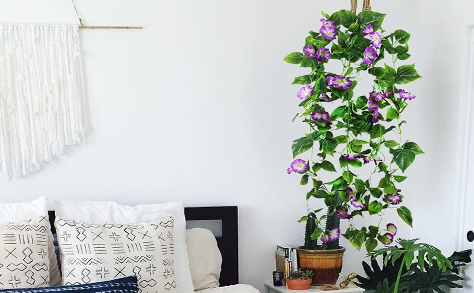 Hanging artificial morning glory vine garland with purple flowers and green leaves, displayed in a bedroom setting.