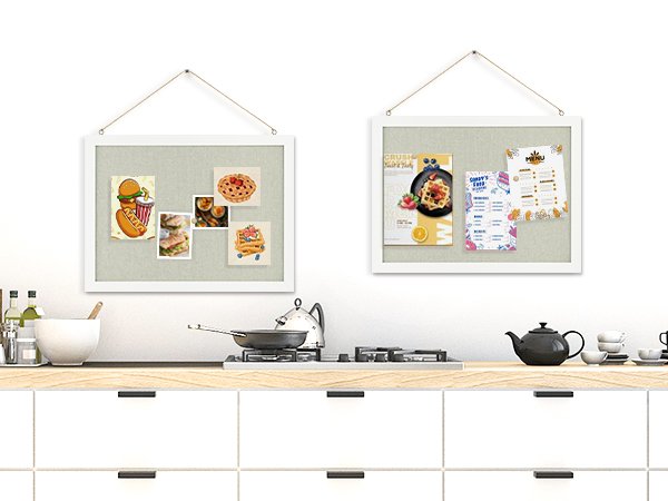 Two white-framed cork boards hanging on a wall, displaying various food-themed pictures and menus.