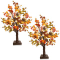 Two prelit fall tabletop trees with warm LEDs, eucalyptus leaves, pine cones, and berries on white background.
