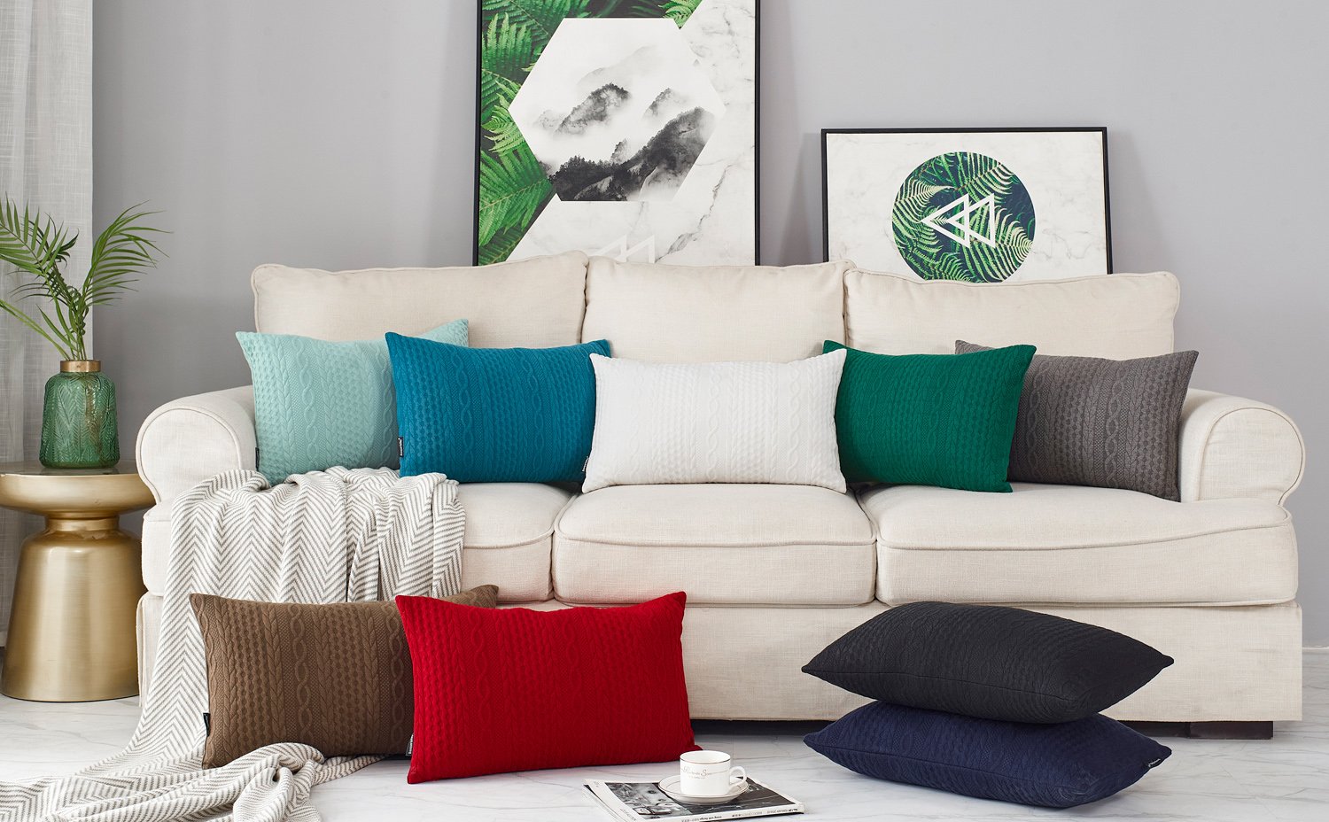 Assortment of knit pillow covers in various colors arranged on a sofa and floor.