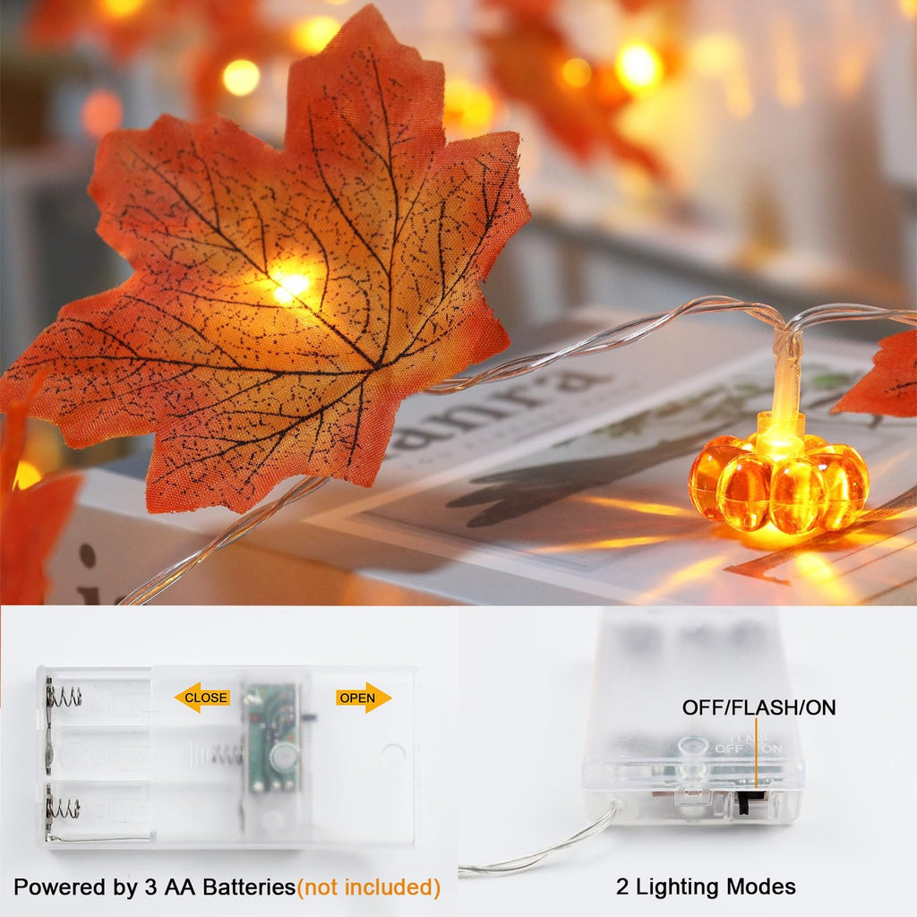 Close-up of fall string lights with maple leaves and pumpkins, showing battery pack and modes.