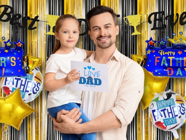 Father and daughter celebrating Father's Day with balloons and banners