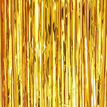 Gold metallic fringe backdrop curtain hanging vertically, close-up view.
