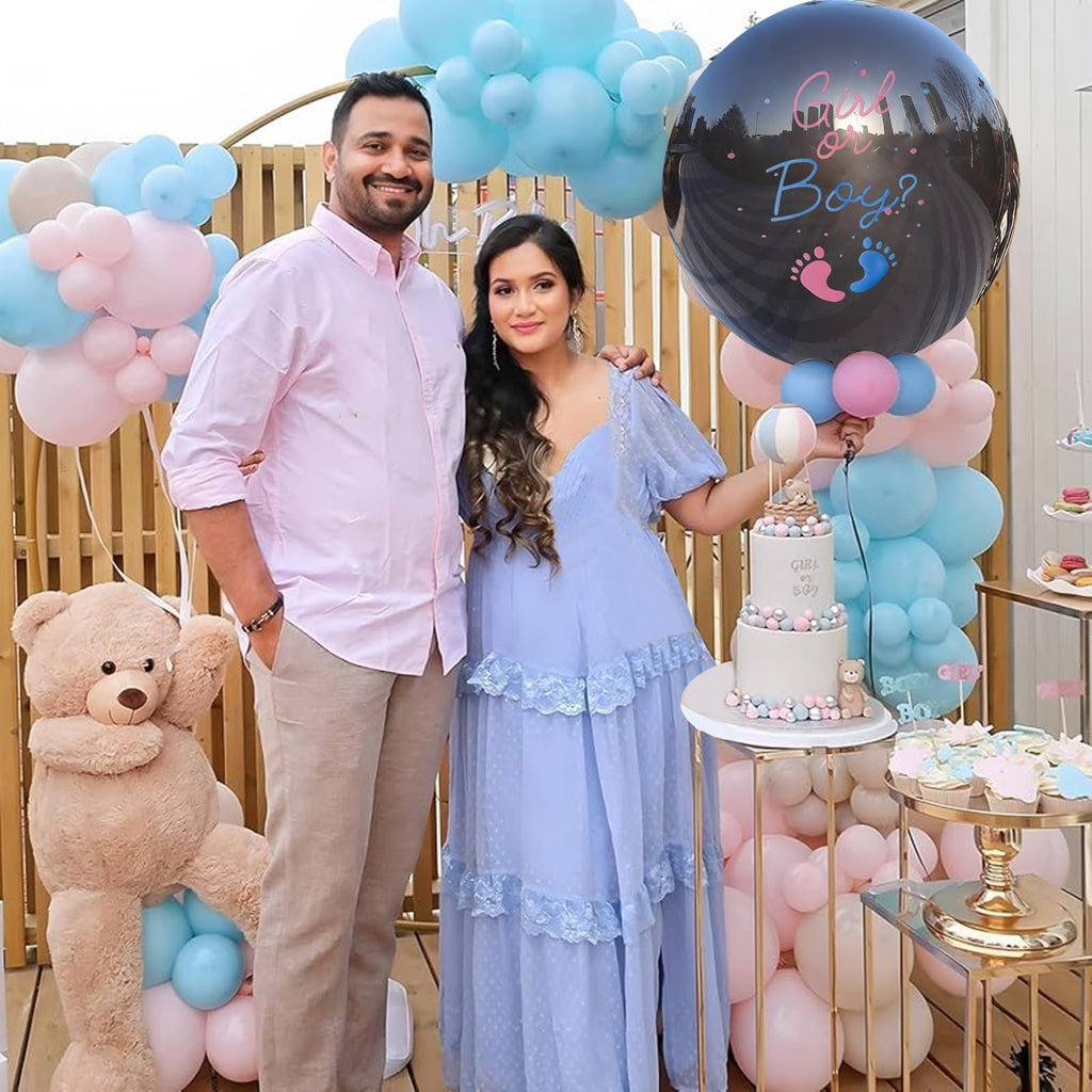 Couple posing at a gender reveal party with a large black balloon that says 'Girl or Boy?'