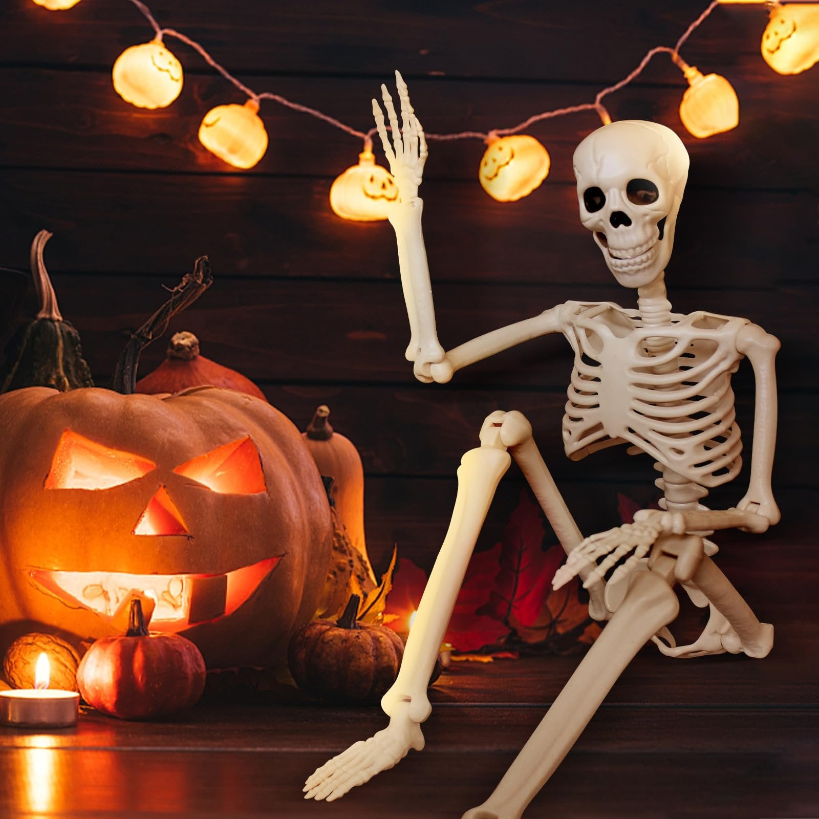 Posable skeleton decoration sitting next to a carved pumpkin and Halloween lights