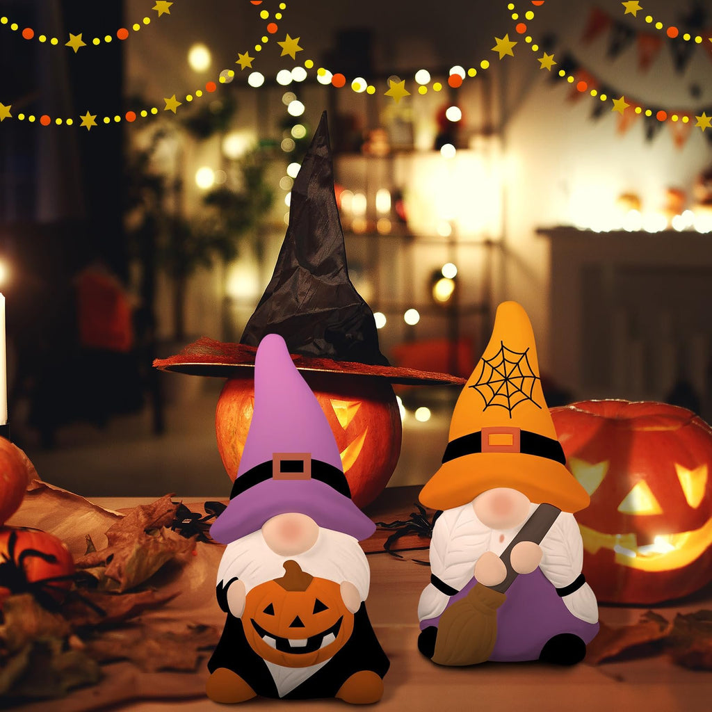 Two Halloween gnomes, one holding a pumpkin and the other a broom, with carved pumpkins and festive lights in the background.