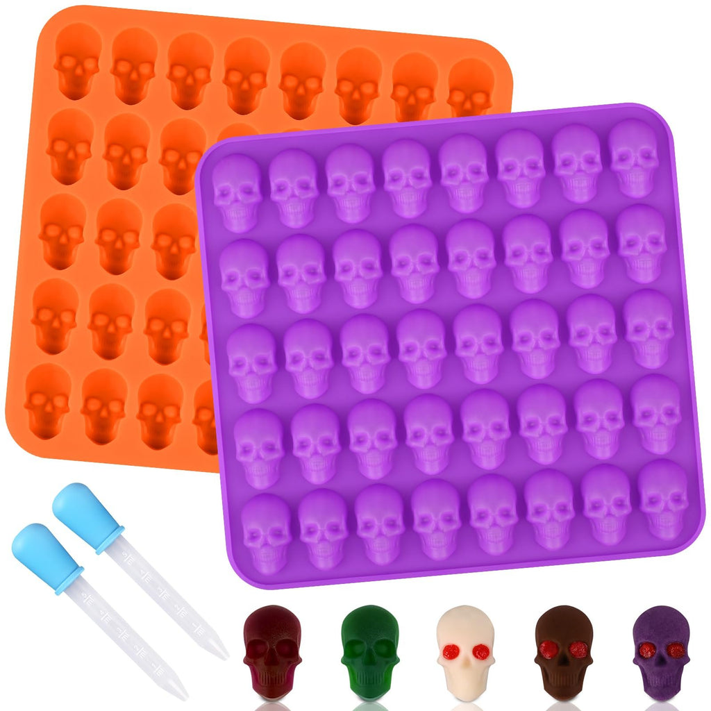 Two silicone skull candy molds, one orange and one purple, with two droppers and five finished skull candies below.