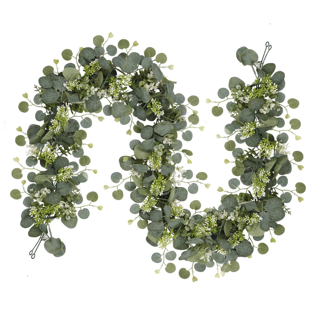 Faux eucalyptus garland with silver dollar leaves and white flowers on a white background