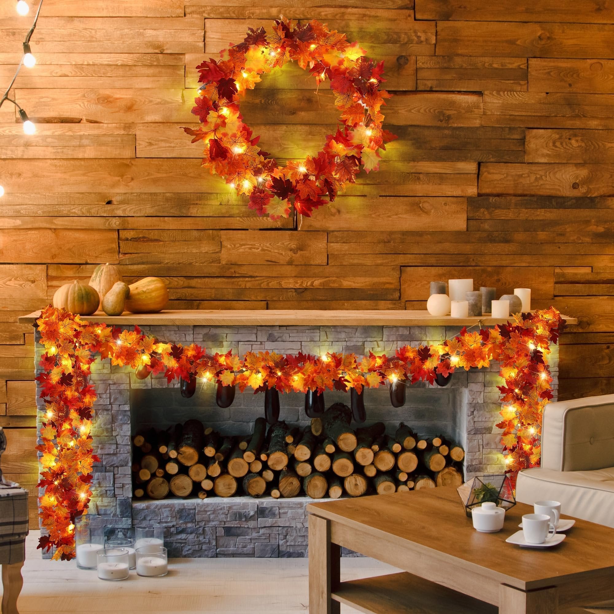 Artificial maple leaf garland and wreath with LED lights decorating a fireplace mantel and wall