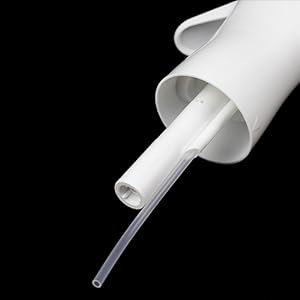 Close-up of a white continuous mist spray bottle nozzle and tube on a black background.