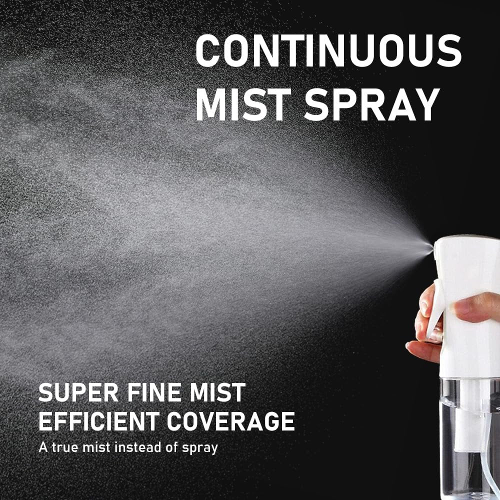 Hand holding a white continuous mist spray bottle spraying a fine mist against a black background.