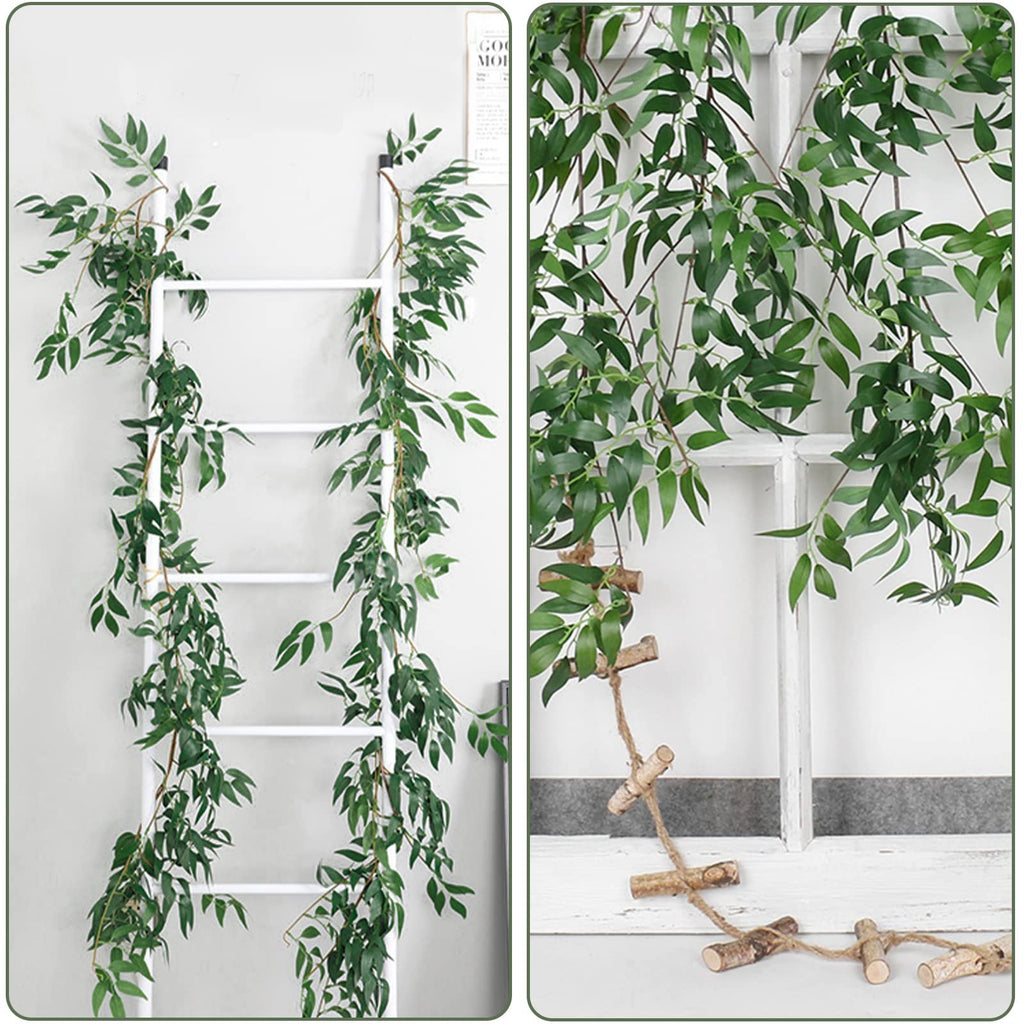 Artificial willow vine garland with green leaves draped over a white ladder and window frame