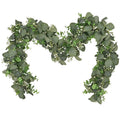 Artificial eucalyptus garland with small white flowers on a white background