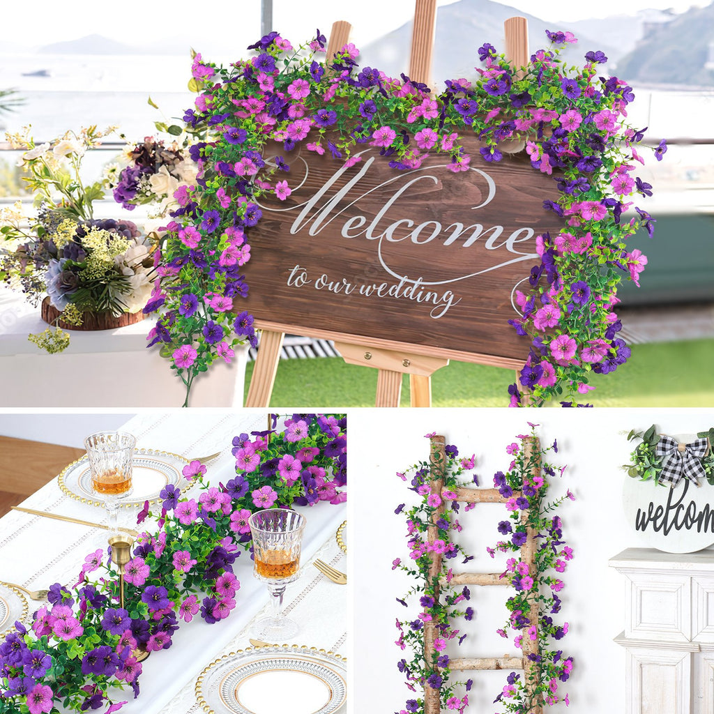 Artificial purple and pink daisy flower garlands draped on a welcome wedding sign and table setting