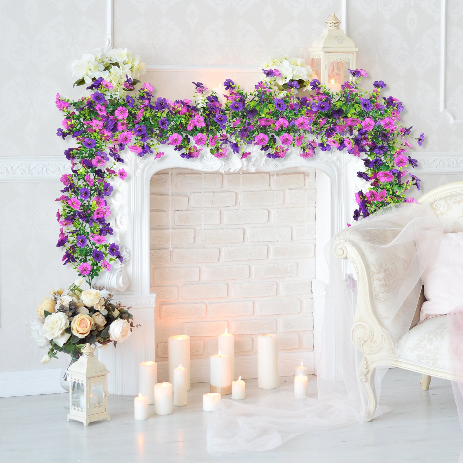 Artificial purple and pink daisy flower garland draped over a white fireplace mantel with candles and flowers.