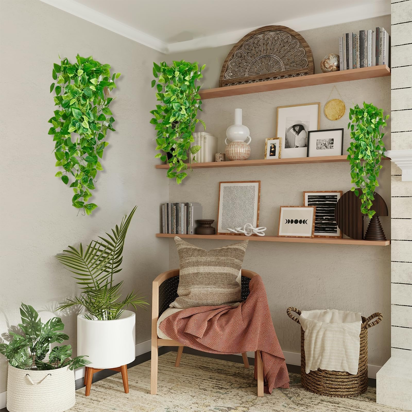 Two artificial ivy hanging vines with green leaves displayed in a room with shelves and a chair.