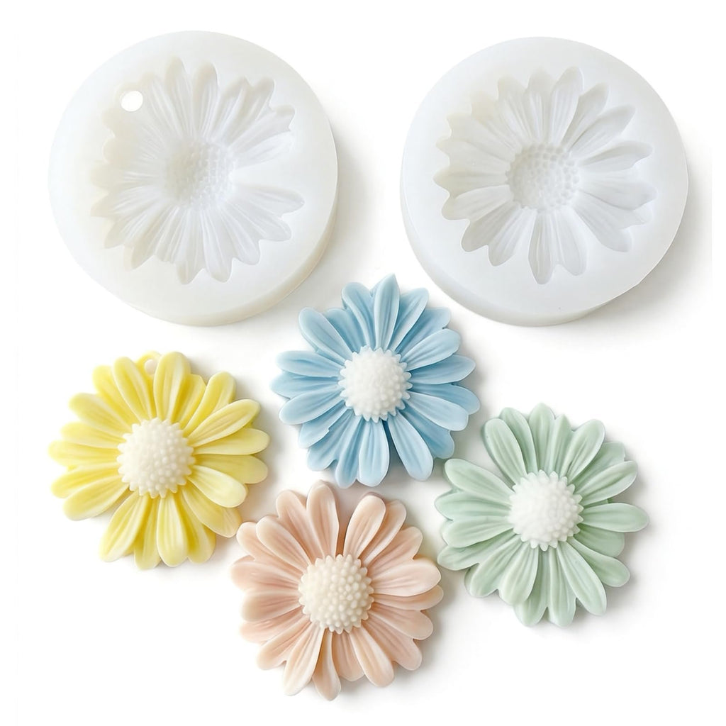 Two daisy-shaped silicone molds and five colorful flower-shaped soap/wax melts on a white background.