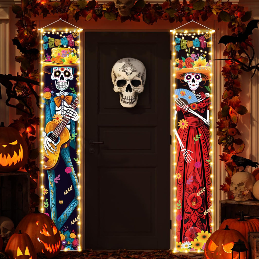 Dia de los Muertos porch banners with skeleton couple, one playing guitar, the other holding a fan, illuminated by string lights.