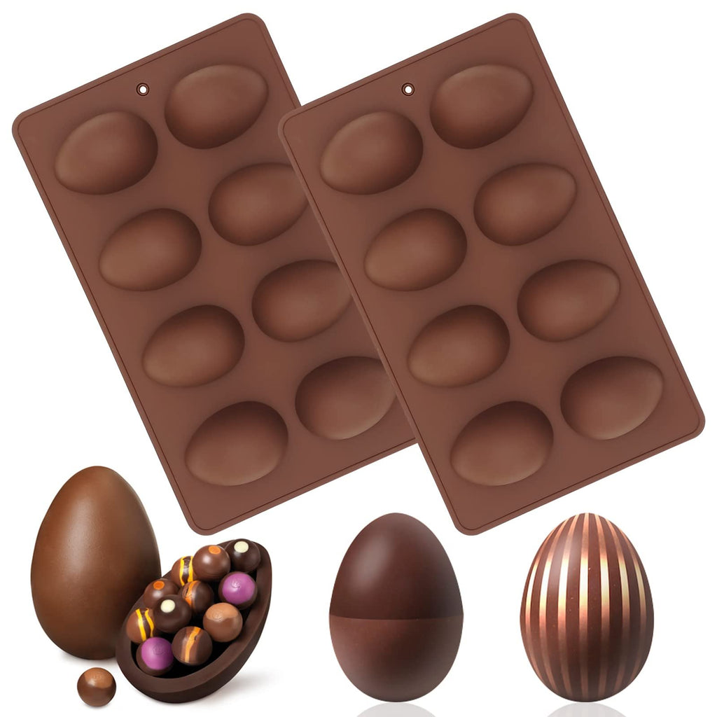 Two brown silicone Easter egg molds with chocolate eggs and candies on a white background