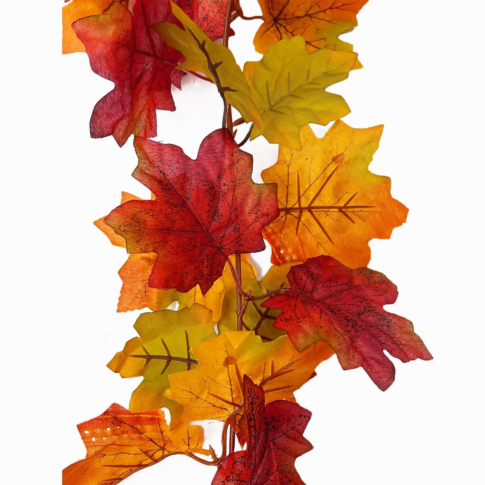 Close-up of an artificial fall maple leaf garland with red, orange, and yellow leaves on a white background.