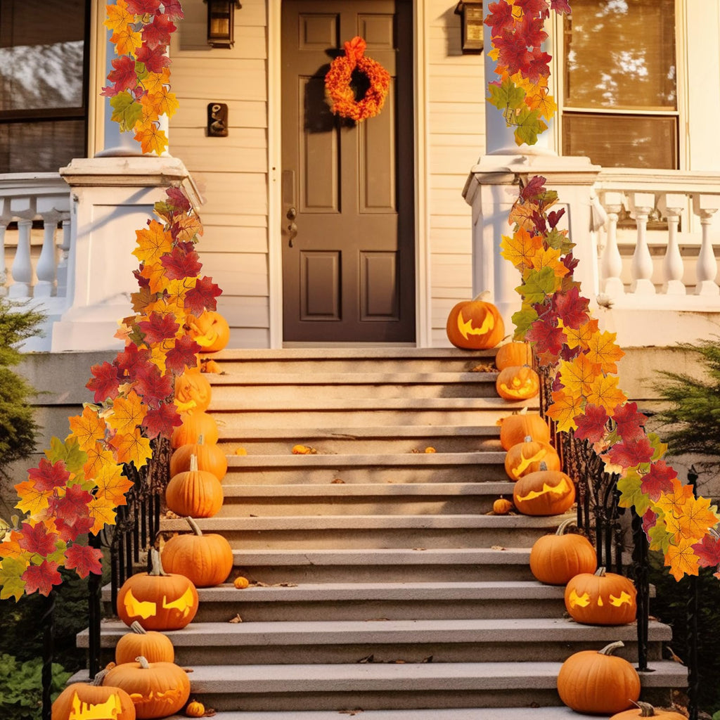 Front porch stairs decorated with carved pumpkins and artificial maple leaf garlands for autumn.