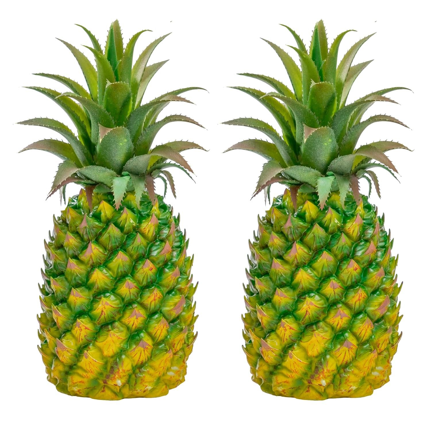 Two artificial green pineapples with textured yellow and green bodies and spiky green leaves, isolated on a white background.