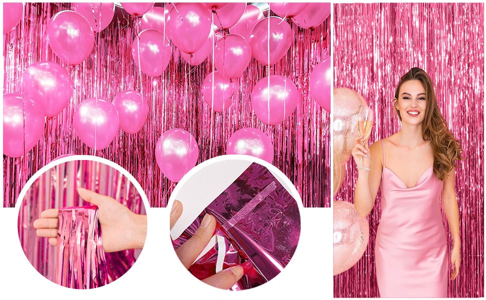 Pink tinsel foil fringe backdrop with pink balloons and a woman holding champagne glasses