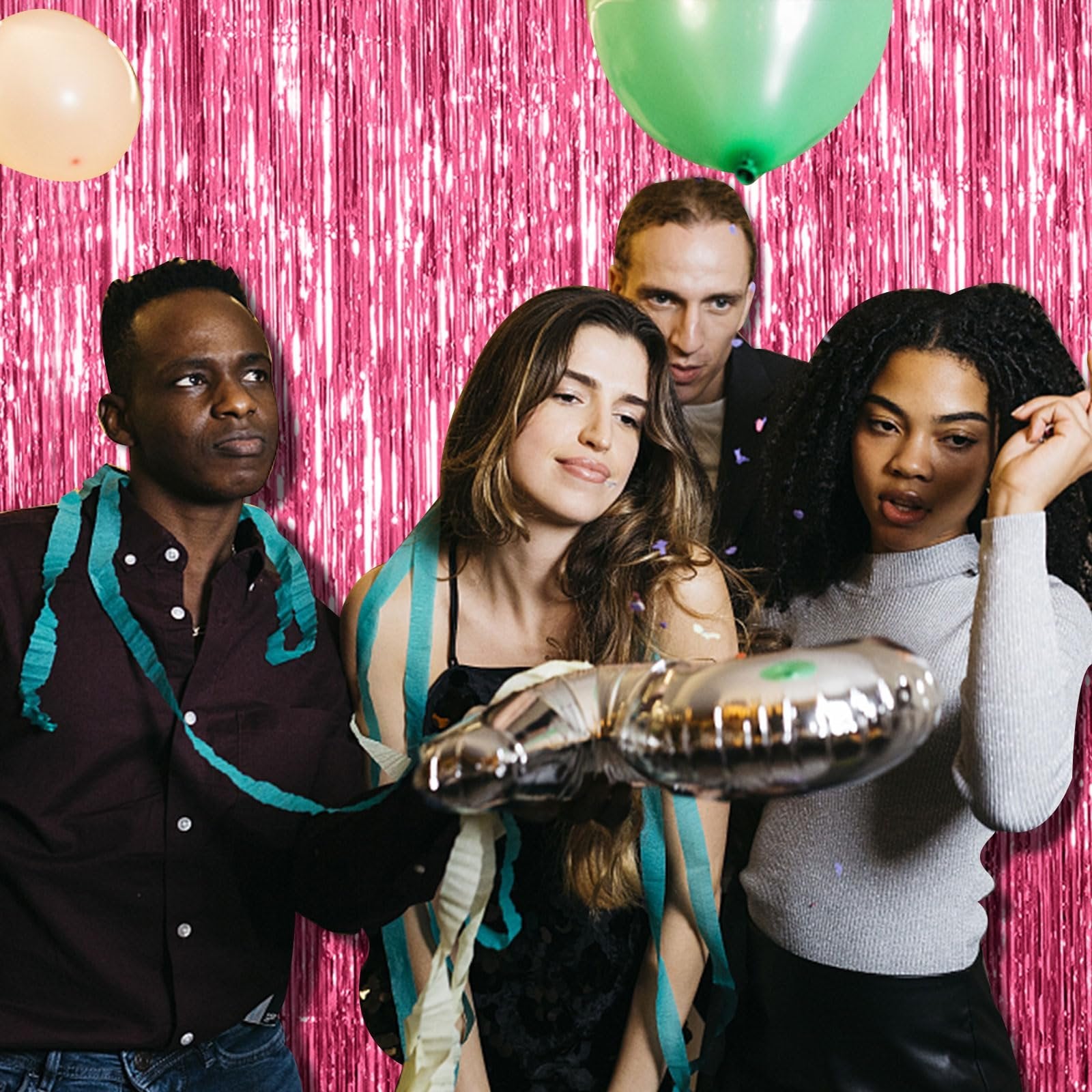 Four people posing in front of a pink tinsel fringe backdrop with balloons and streamers