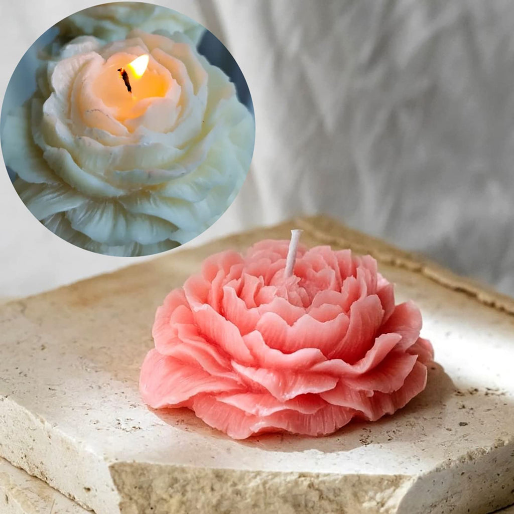 Pink peony-shaped candle on a stone surface with a circular inset showing a lit white peony candle