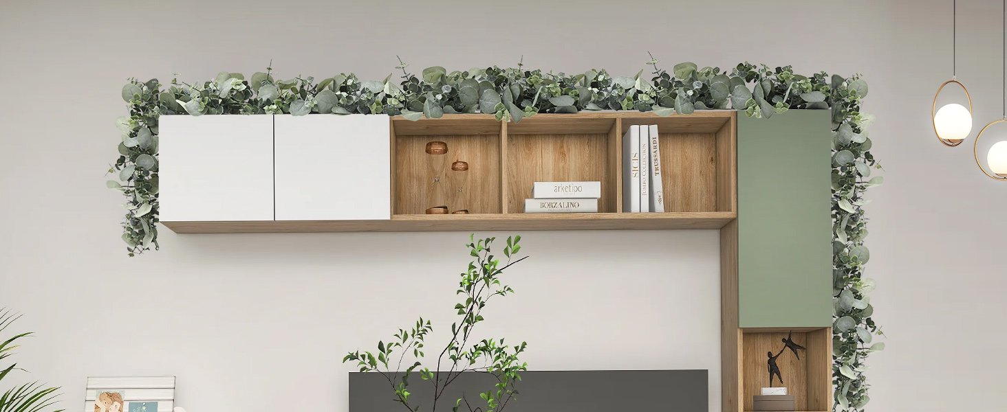 Artificial eucalyptus garland draped over a modern shelving unit with white and green cabinets.