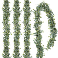 Artificial eucalyptus garland with silver dollar leaves and small white flowers, displayed in a curved arrangement on a white background.