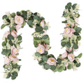 Artificial eucalyptus garland with pink roses and white flowers on a white background