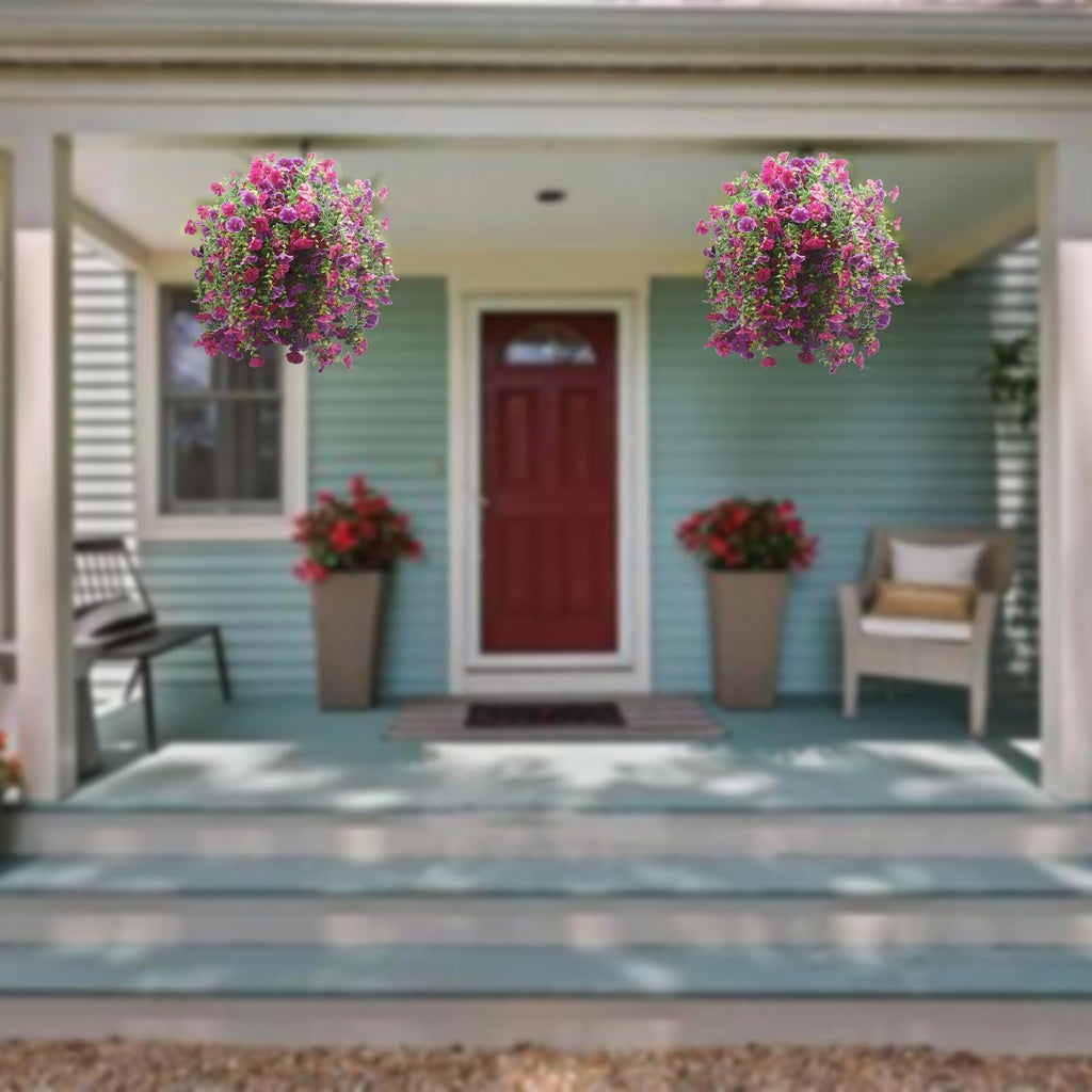 Two hanging baskets of purple and pink artificial morning glory flowers on a porch.