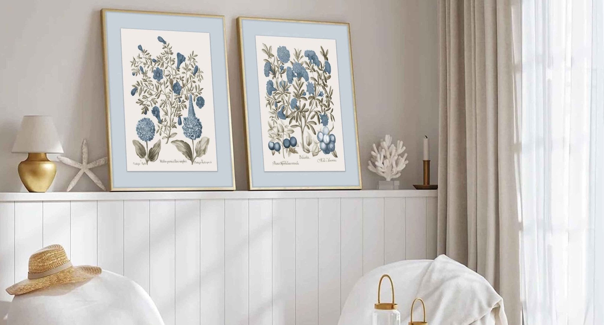 Two framed botanical prints of blue flowers and berries displayed on a shelf in a room.