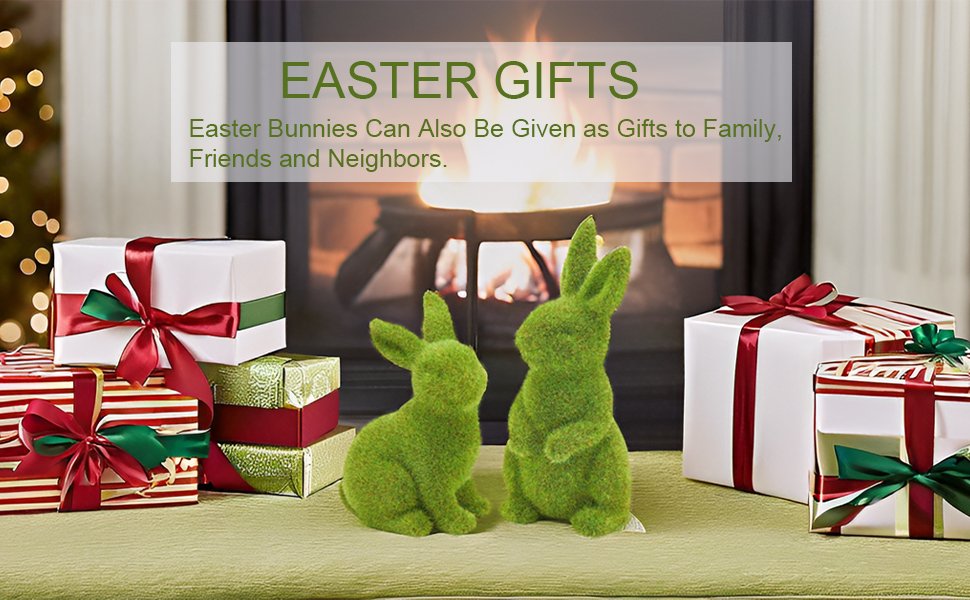 Two flocked green moss bunny figurines sit near wrapped gifts in front of a fireplace.