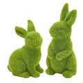 Two flocked green moss bunny figurines on a white background, one sitting and one standing.