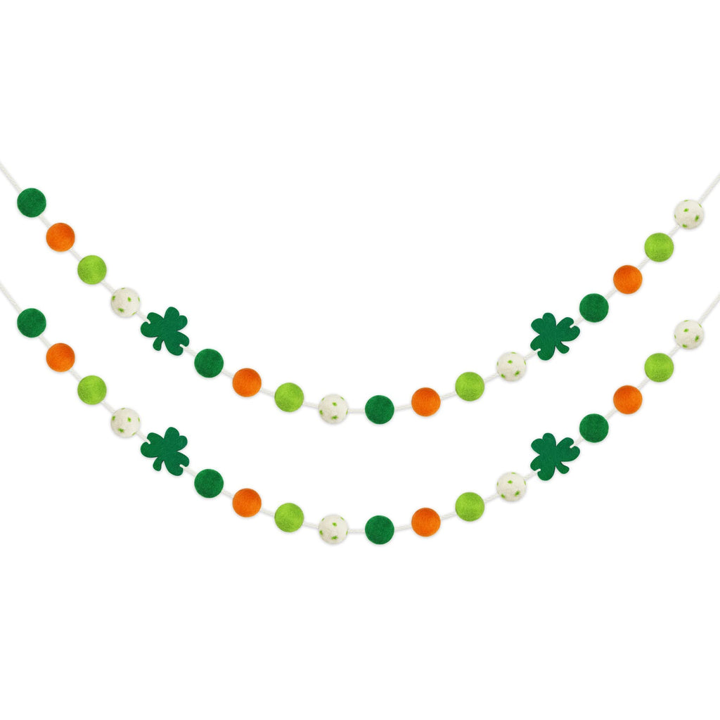 Two St. Patrick's Day felt ball garlands with shamrocks and pom poms in green, orange, and white.