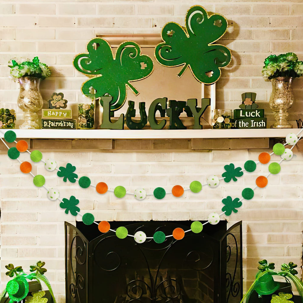 St. Patrick's Day felt ball garlands with shamrocks draped over a fireplace mantle.