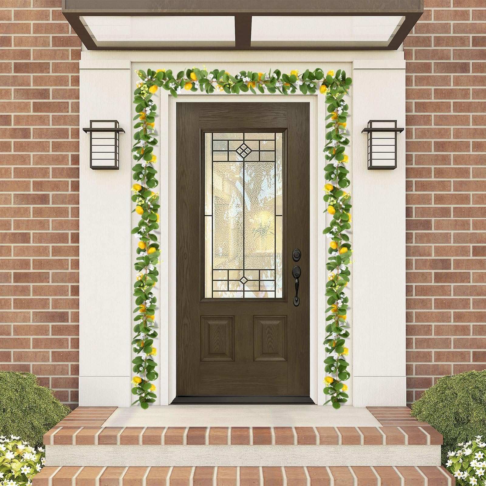 Artificial lemon vine garland with green leaves and yellow lemons draped around a front door.