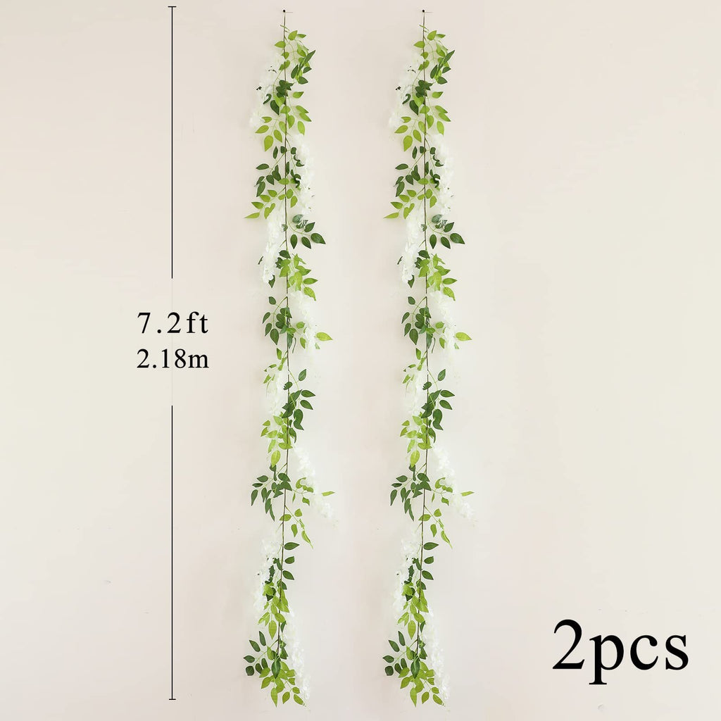 Two white faux wisteria garlands with green leaves hanging vertically against a cream wall, with size and quantity indicators.