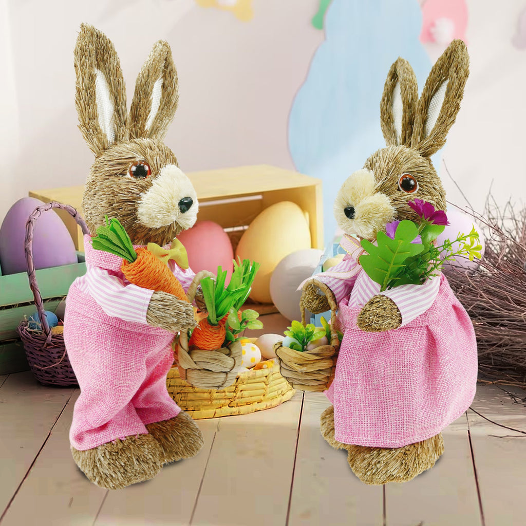 Two sisal bunny figurines in pink outfits holding carrots and flowers, with Easter eggs and baskets in the background.