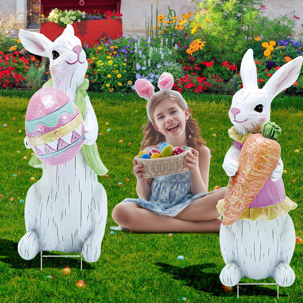 Two Easter bunny yard signs flanking a smiling girl holding a basket of eggs in a garden setting